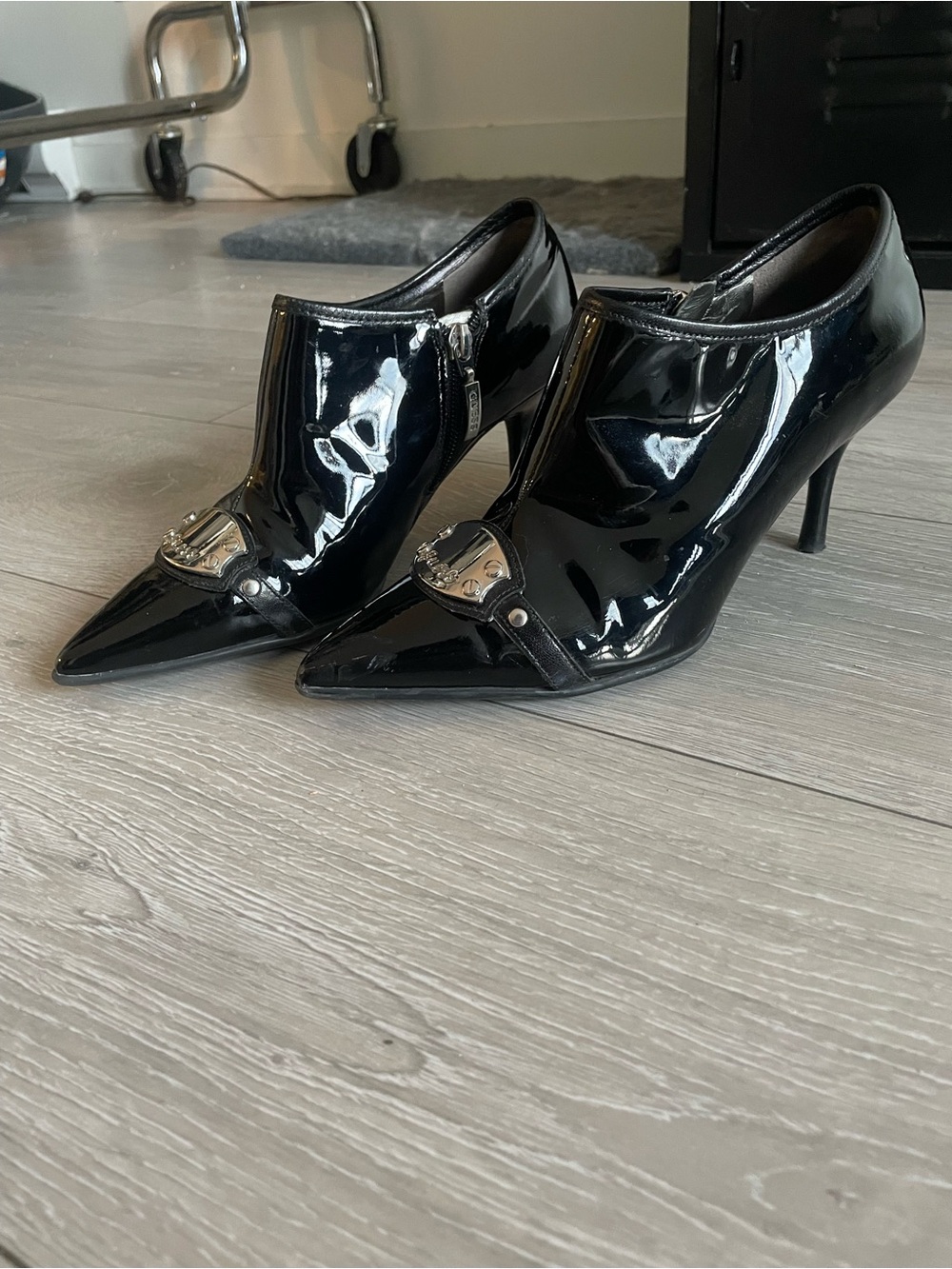 GUESS Black Patent Pointed-Toe Heeled Booties with Silver Accent